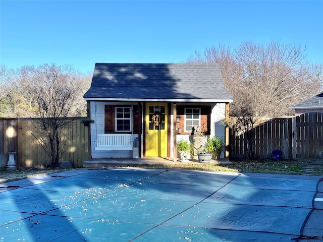 view of swimming pool featuring an outbuilding, a fenced in pool, fence, and an exterior structure