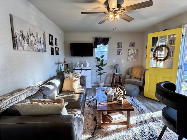 living room featuring a ceiling fan and wood finished floors