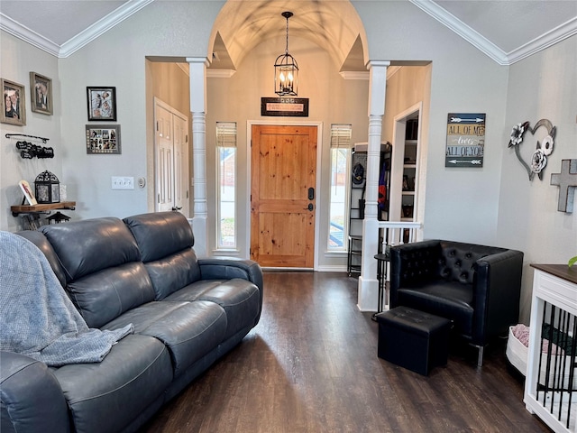 entrance foyer with vaulted ceiling, ornamental molding, decorative columns, wood finished floors, and arched walkways