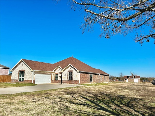 single story home featuring a garage and a front lawn