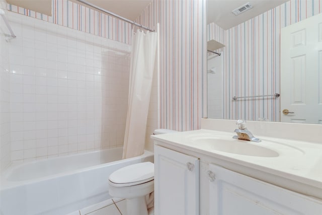 full bathroom featuring tile patterned floors, toilet, vanity, and shower / bath combo