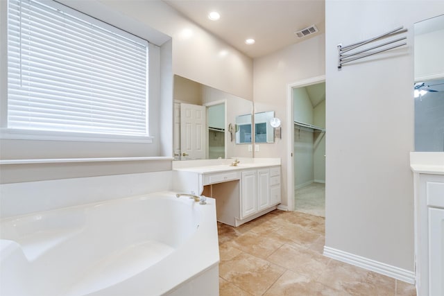 bathroom featuring ceiling fan, vanity, and a bath