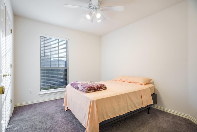 bedroom with dark colored carpet and ceiling fan