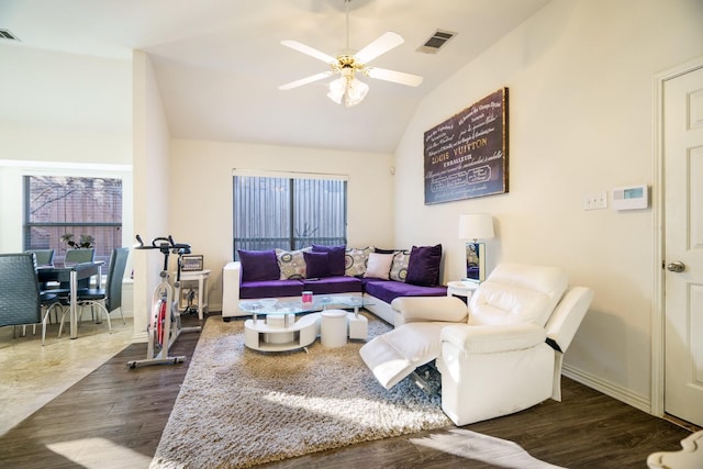 living room with ceiling fan, dark hardwood / wood-style flooring, and vaulted ceiling