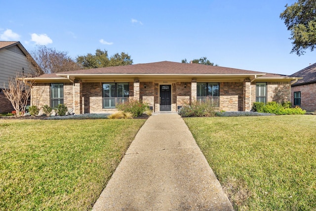 ranch-style house with roof with shingles, a front lawn, and brick siding