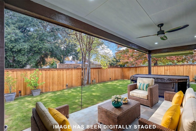 view of patio with outdoor lounge area, ceiling fan, and a hot tub