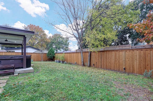 view of yard with a hot tub