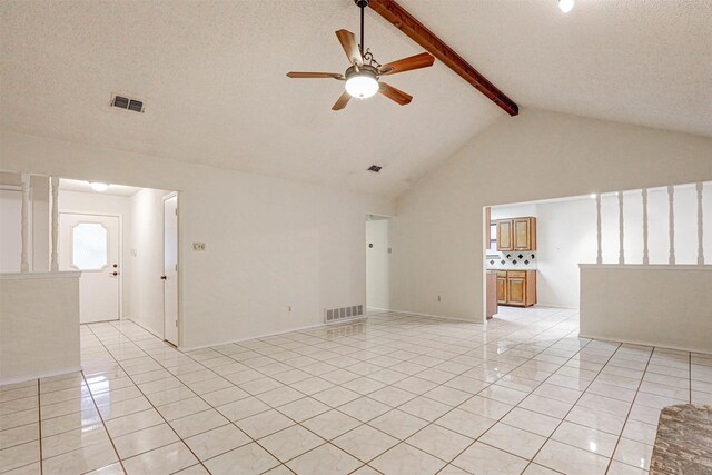 tiled spare room featuring beamed ceiling, ceiling fan, a textured ceiling, and high vaulted ceiling