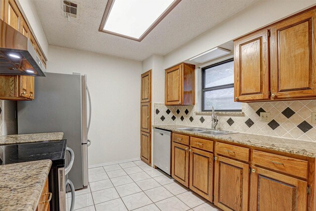 kitchen featuring dishwasher, backsplash, ventilation hood, sink, and range