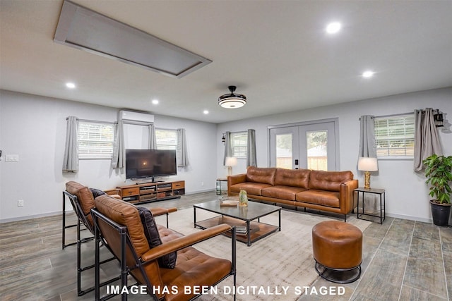 living room featuring hardwood / wood-style floors, french doors, and a healthy amount of sunlight