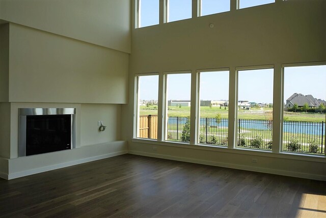 unfurnished sunroom with a water view and a healthy amount of sunlight