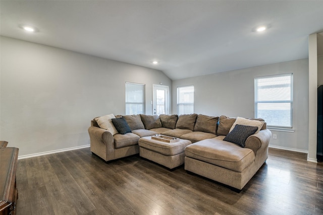 living room featuring vaulted ceiling and dark hardwood / wood-style floors