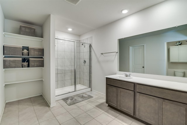 bathroom featuring toilet, tile patterned flooring, vanity, and walk in shower