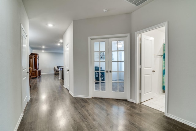 hallway with french doors and light hardwood / wood-style flooring