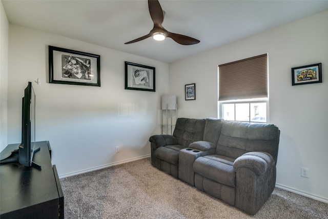 carpeted living room with ceiling fan