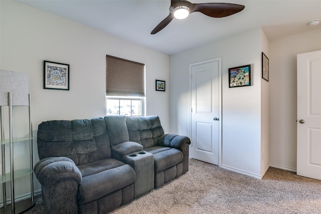 carpeted living room with ceiling fan