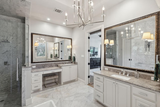 bathroom featuring a shower with door and vanity