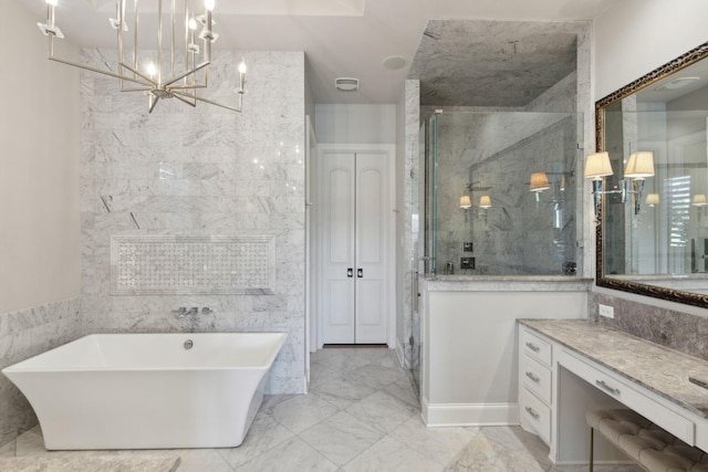 bathroom featuring plus walk in shower, vanity, and a notable chandelier