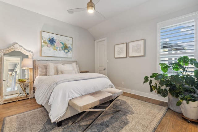 bedroom featuring ceiling fan, wood-type flooring, and vaulted ceiling