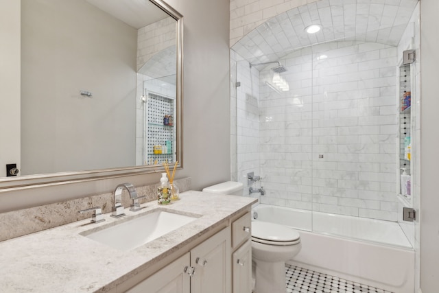 full bathroom with tile patterned floors, toilet, vanity, and tiled shower / bath