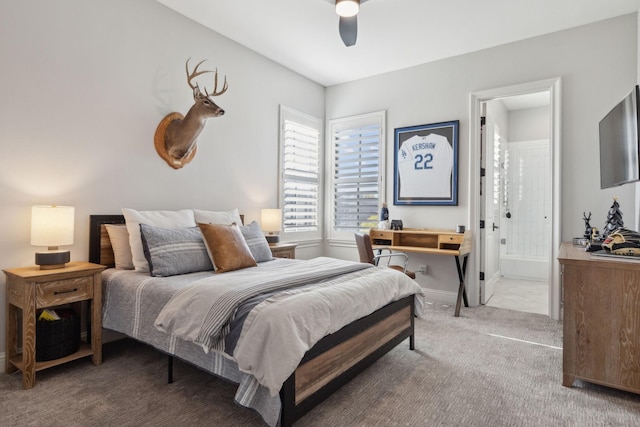 carpeted bedroom featuring connected bathroom and ceiling fan