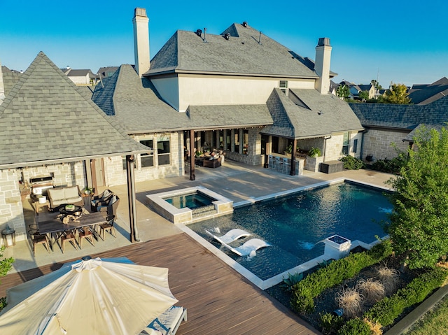 view of swimming pool featuring an outdoor living space, a wooden deck, an in ground hot tub, and a patio