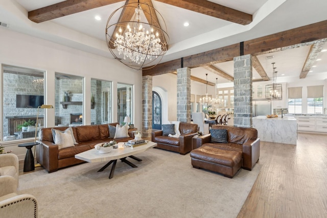 living room featuring hardwood / wood-style flooring, ornate columns, and a fireplace