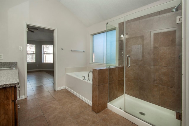 bathroom with vaulted ceiling, separate shower and tub, vanity, and tile patterned floors