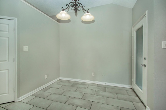 tiled empty room featuring lofted ceiling and a notable chandelier