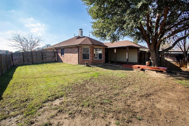 rear view of house with a yard