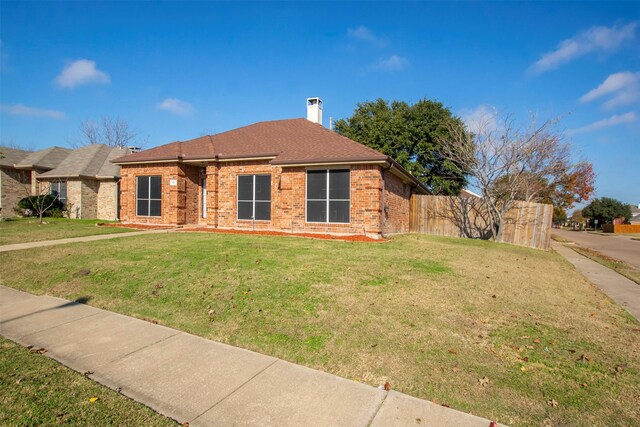 ranch-style house with a front lawn