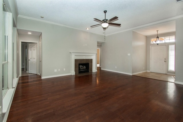 unfurnished living room featuring a textured ceiling, dark hardwood / wood-style flooring, and ornamental molding