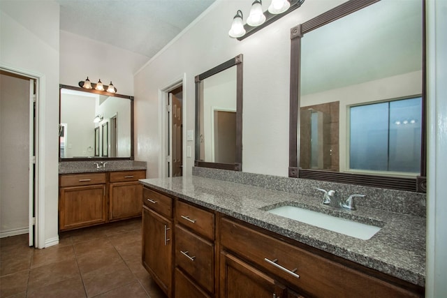 bathroom with vanity, tile patterned flooring, and a shower