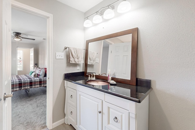 bathroom featuring ceiling fan and vanity