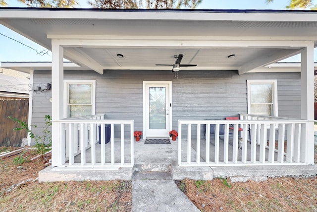 doorway to property featuring a porch and ceiling fan