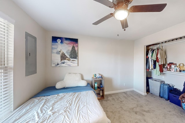 carpeted bedroom featuring ceiling fan, electric panel, and a closet