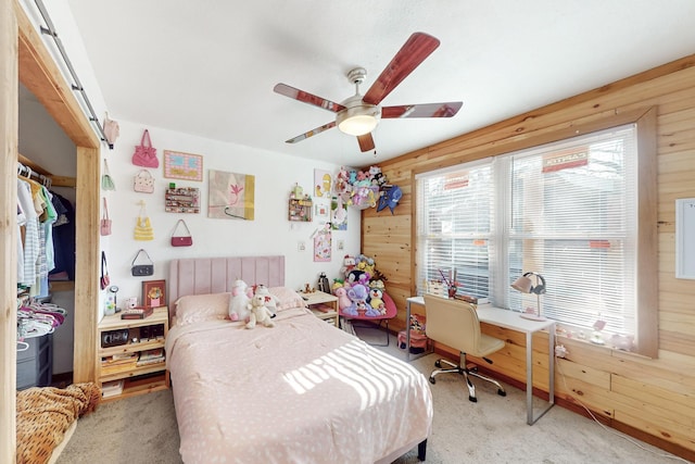 bedroom featuring carpet flooring, ceiling fan, and wooden walls