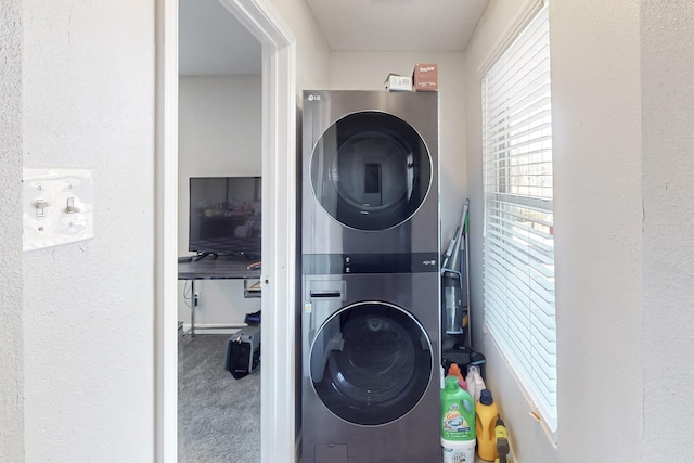 laundry area with carpet floors and stacked washer and clothes dryer