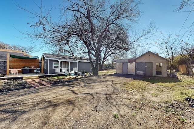 exterior space with cooling unit, an outbuilding, and a wooden deck