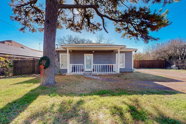 back of house with a lawn and a porch