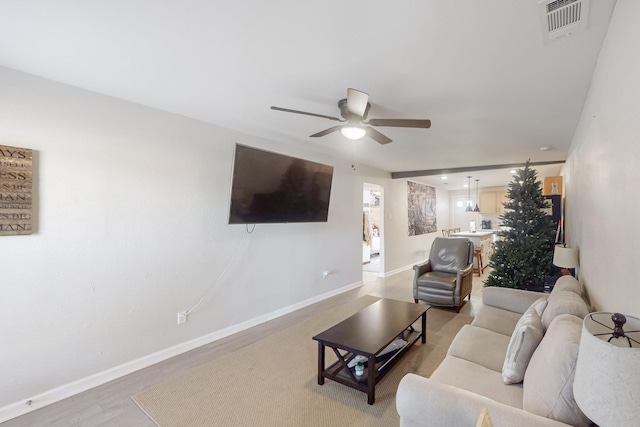 living room featuring ceiling fan and light wood-type flooring