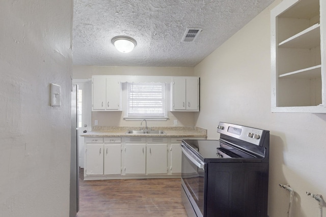 kitchen with stainless steel range with electric stovetop, white cabinets, sink, dark hardwood / wood-style floors, and a textured ceiling