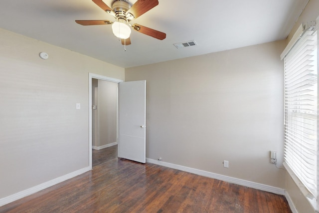 unfurnished room featuring ceiling fan and dark wood-type flooring