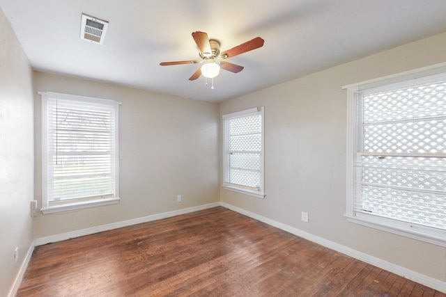 empty room featuring ceiling fan and dark hardwood / wood-style flooring