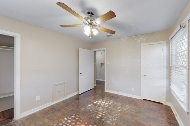 unfurnished bedroom with ceiling fan and dark hardwood / wood-style flooring