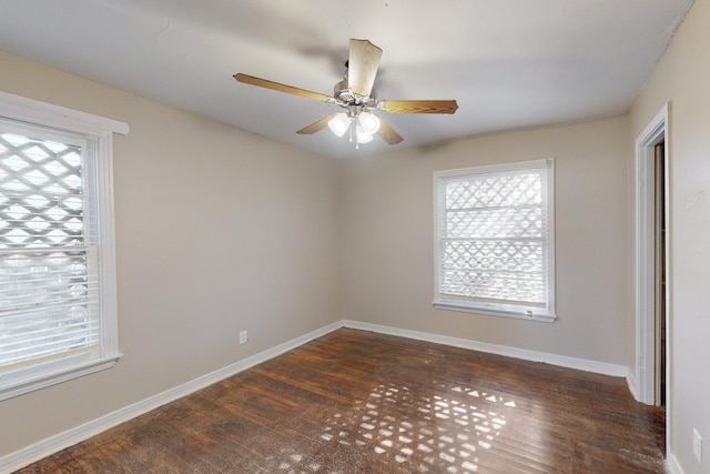 empty room with ceiling fan and dark wood-type flooring