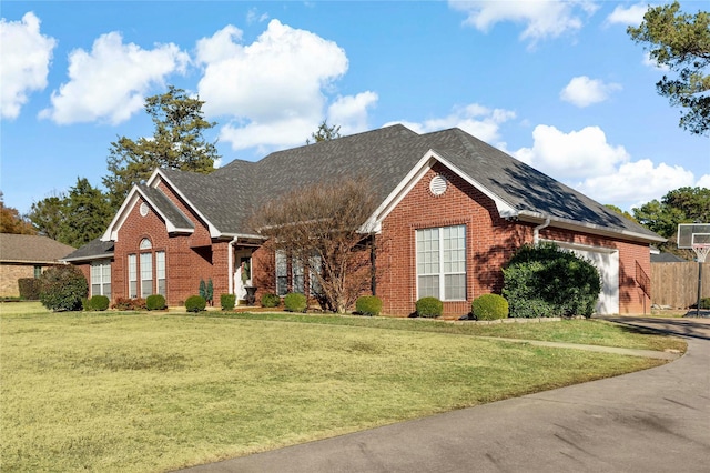 view of front of house featuring a garage and a front lawn