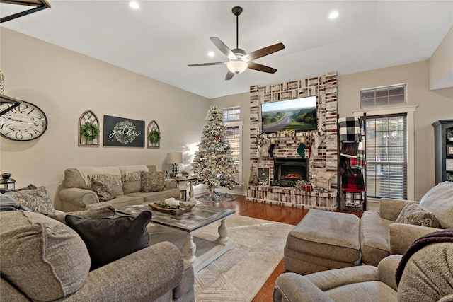 living room with a fireplace, hardwood / wood-style floors, plenty of natural light, and ceiling fan