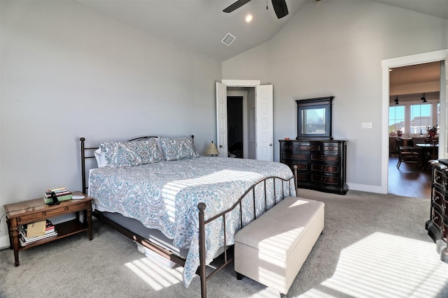 carpeted bedroom featuring ceiling fan and high vaulted ceiling