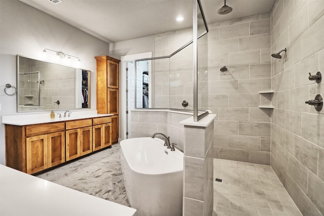 bathroom featuring vanity and shower with separate bathtub